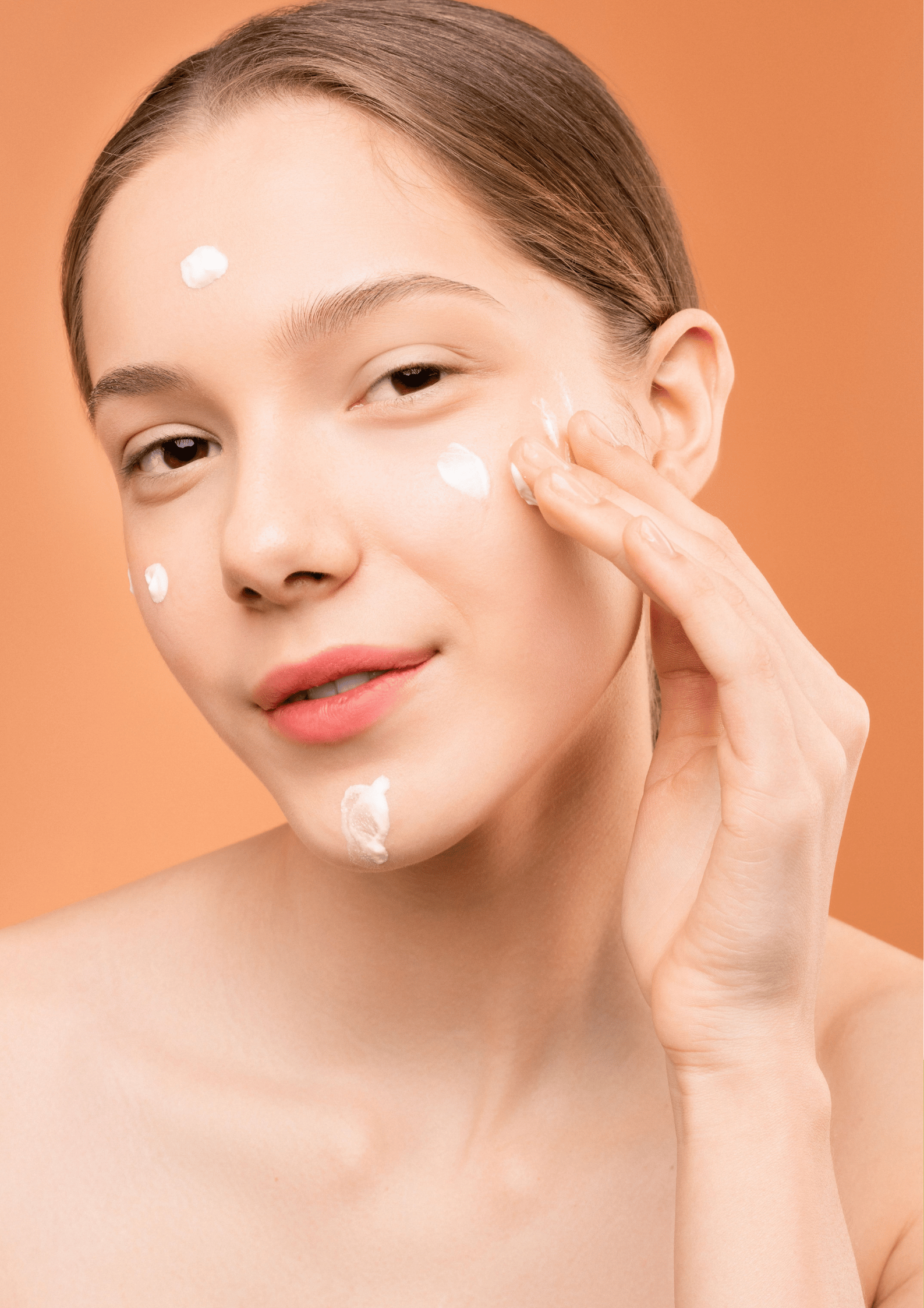 teenage girl applying moisturizer in skincare routine