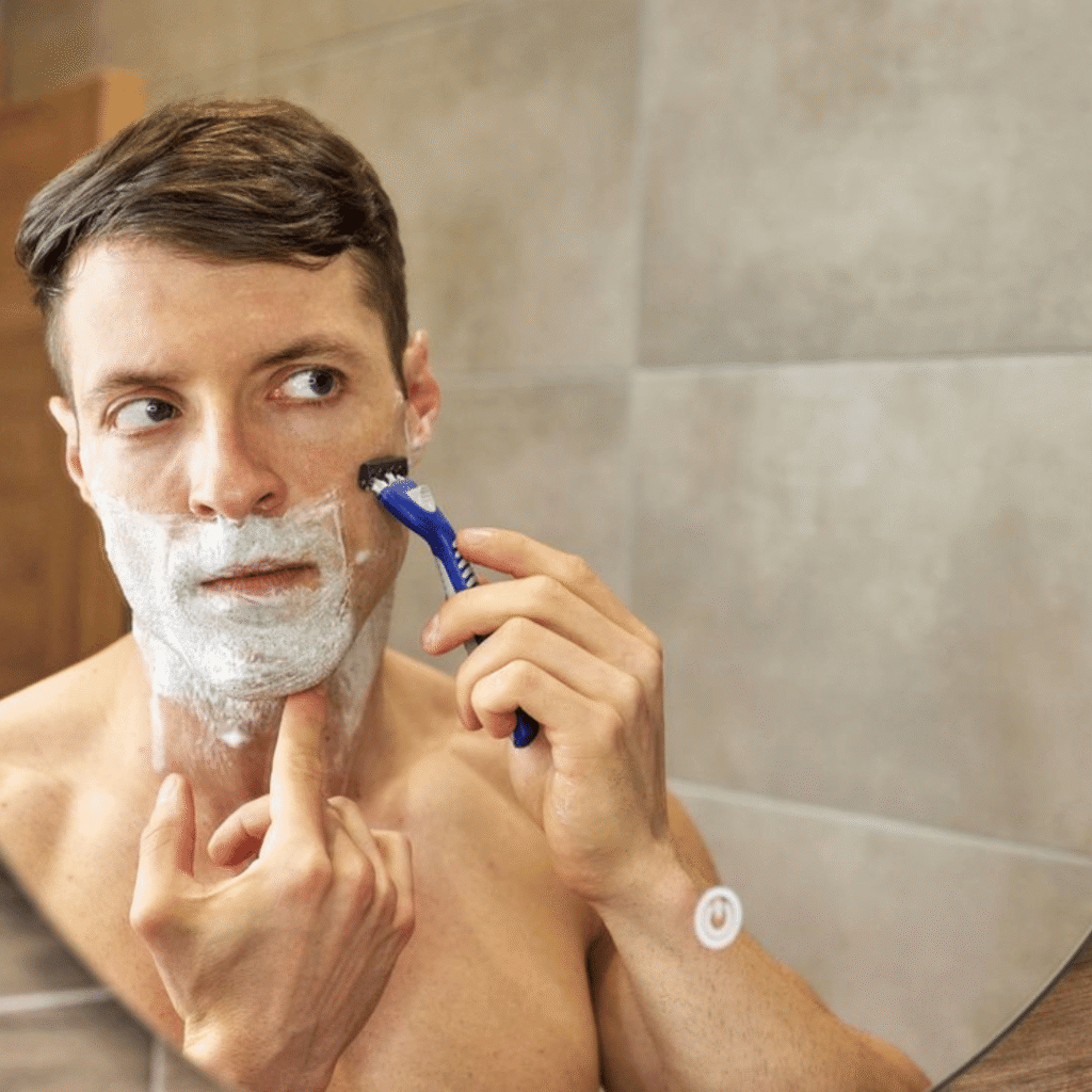 A man shaving carefully to avoid razor bumps and skin irritation